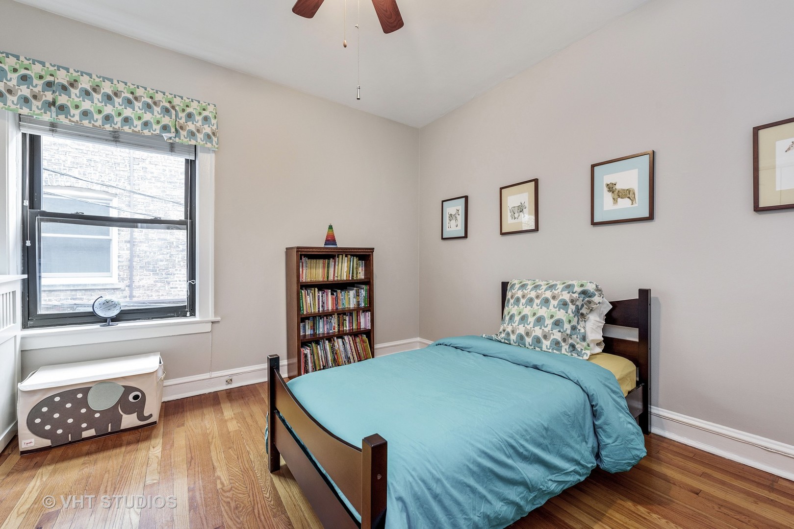 535 West Addison Street, Unit 2E Chicago, IL 60613 - Photo 10 of 11 a bedroom with a bed and wooden floor