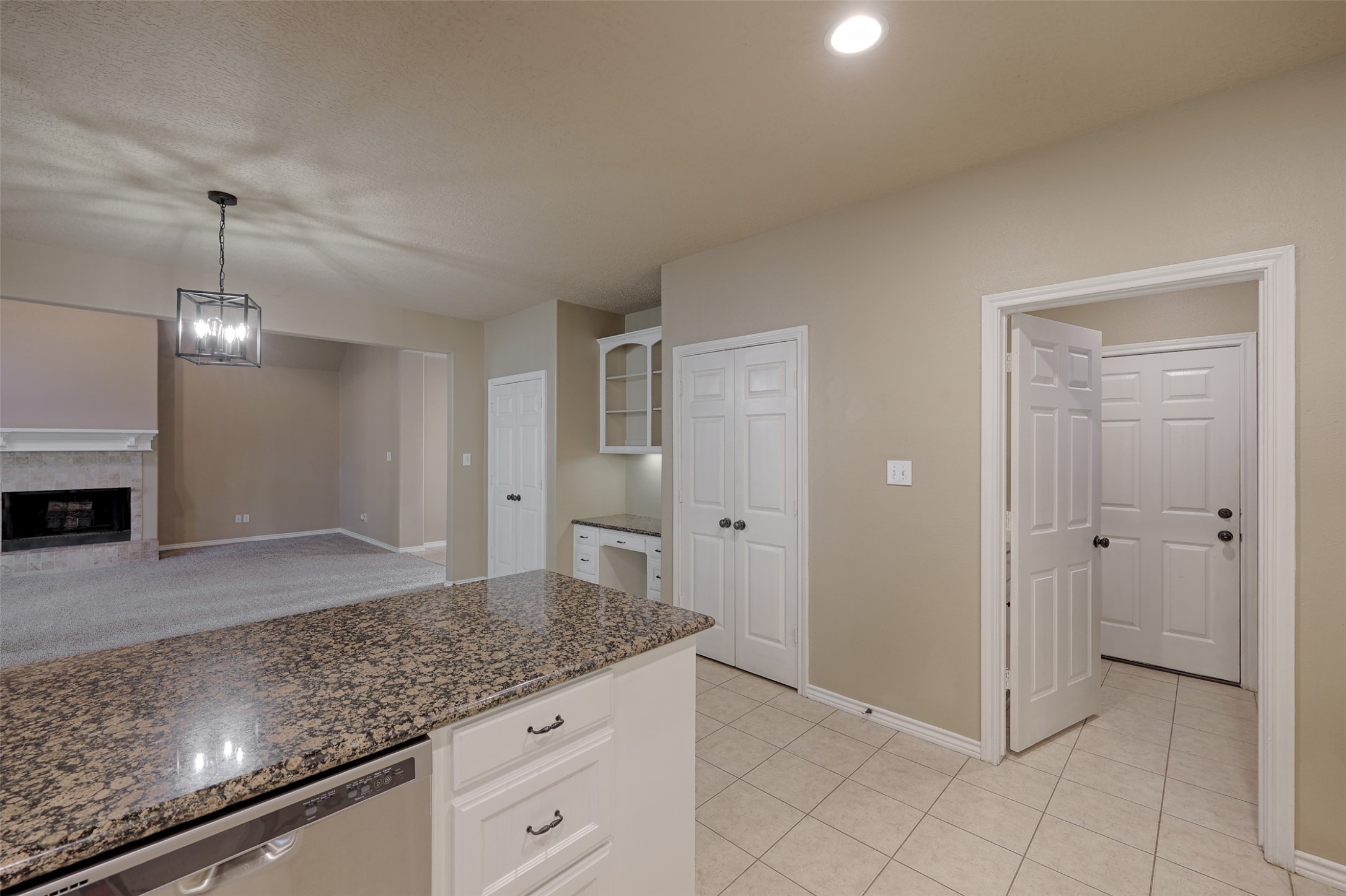 14918 Pollux Drive Willis, TX 77318 - Photo 17 of 46 a view of a kitchen with granite countertop cabinets and chandelier