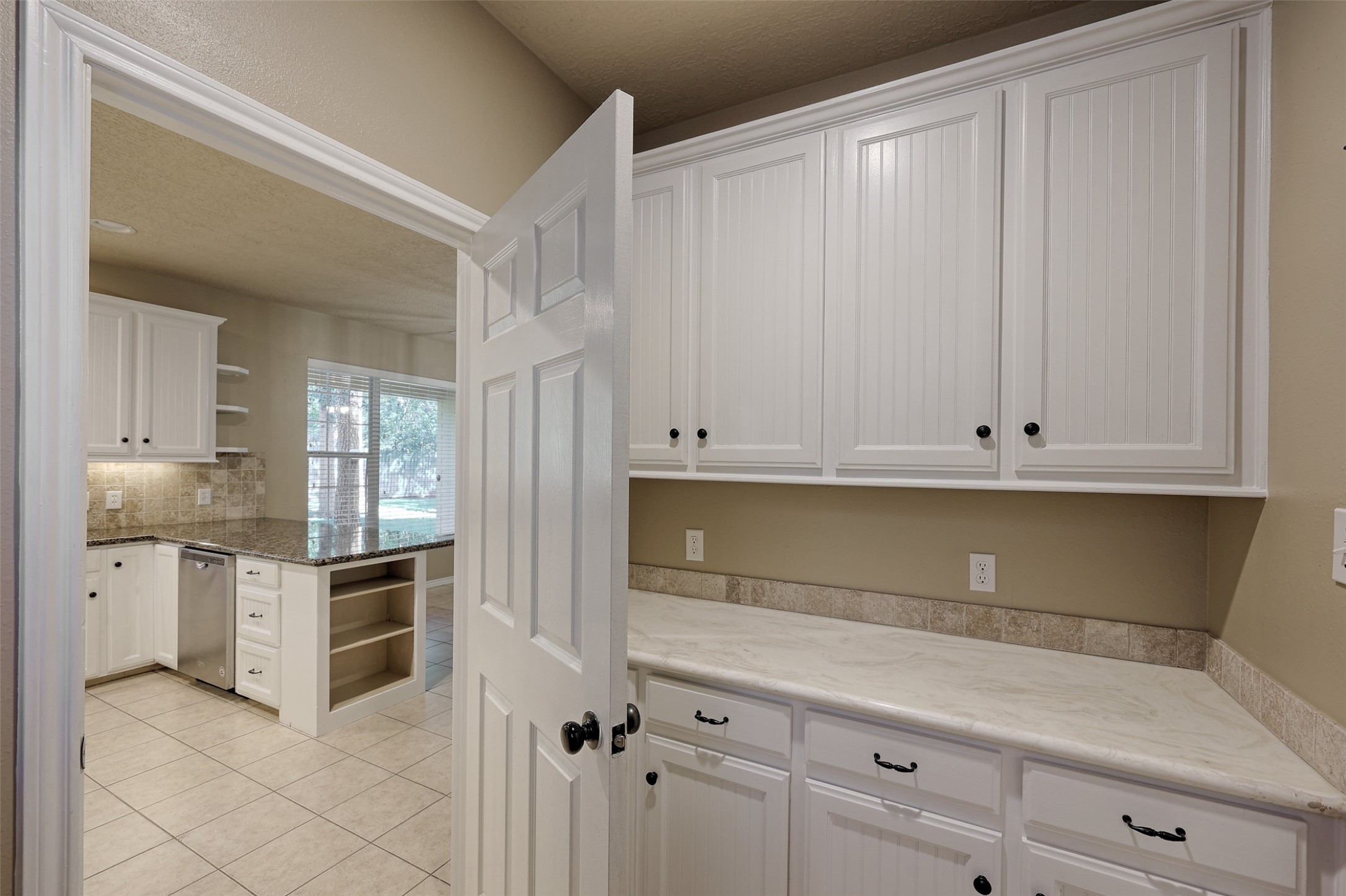 14918 Pollux Drive Willis, TX 77318 - Photo 19 of 46 a kitchen with white cabinets and white appliances