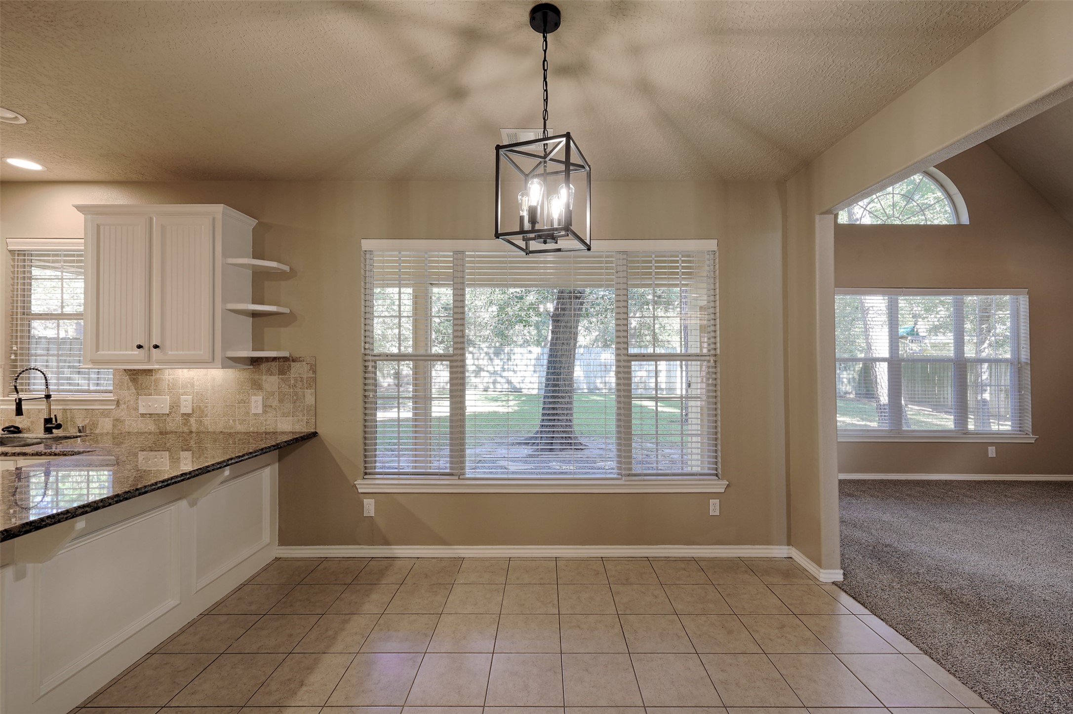 14918 Pollux Drive Willis, TX 77318 - Photo 20 of 46 a view of an empty room with a kitchen