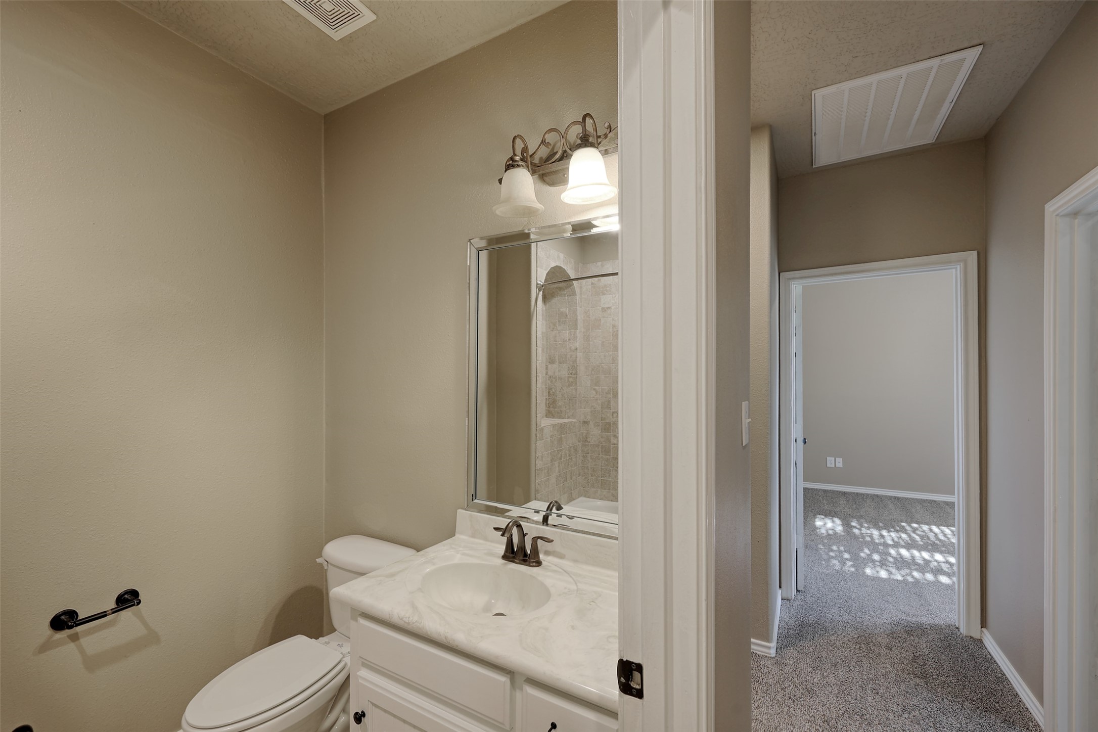 14918 Pollux Drive Willis, TX 77318 - Photo 24 of 46 a bathroom with a sink vanity mirror and toilet