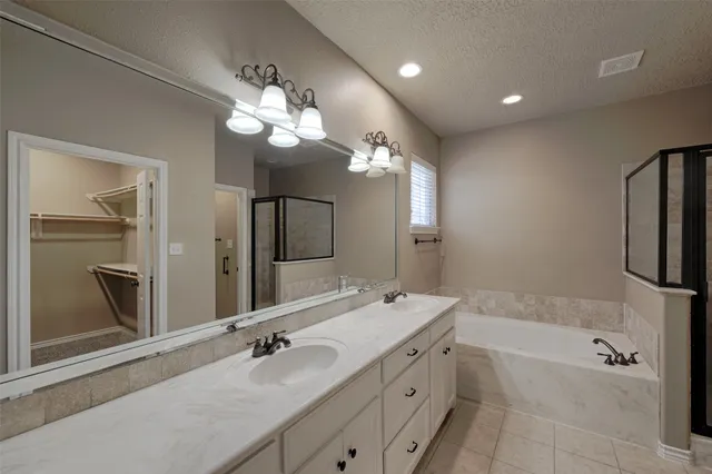 a bathroom with a tub and shower