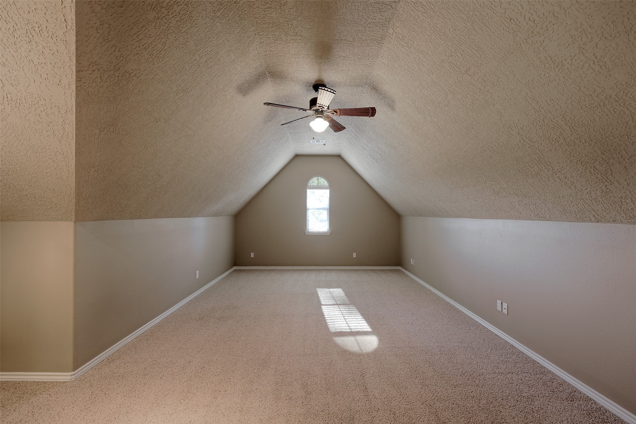 14918 Pollux Drive Willis, TX 77318 - Photo 33 of 46 an empty room with a chandelier fan and windows