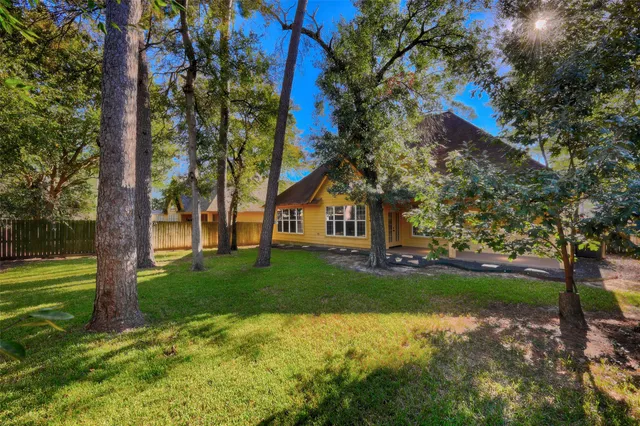 a view of a house with a yard and tree s