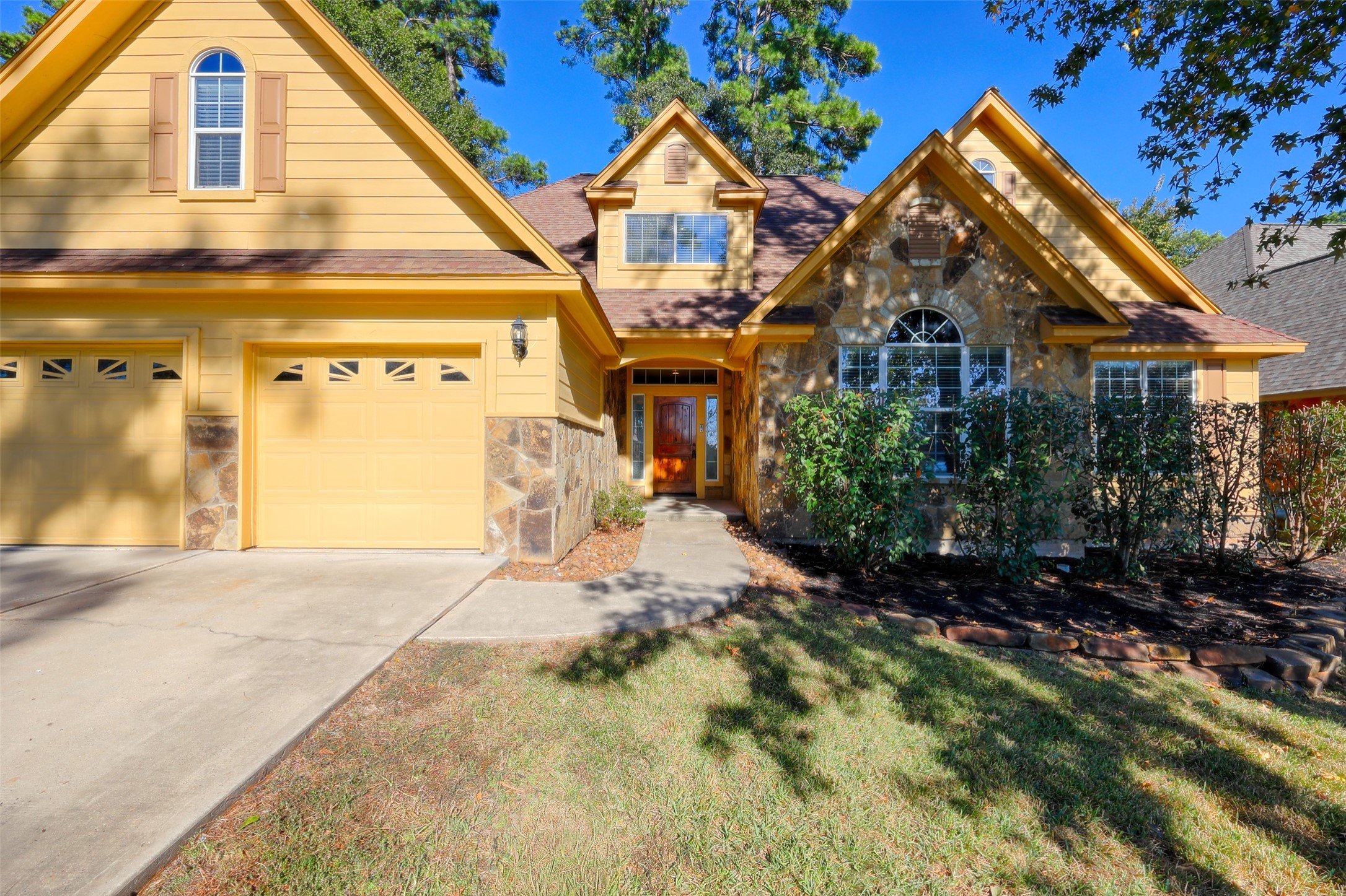 14918 Pollux Drive Willis, TX 77318 - Photo 4 of 46 a front view of a house with a yard and garage