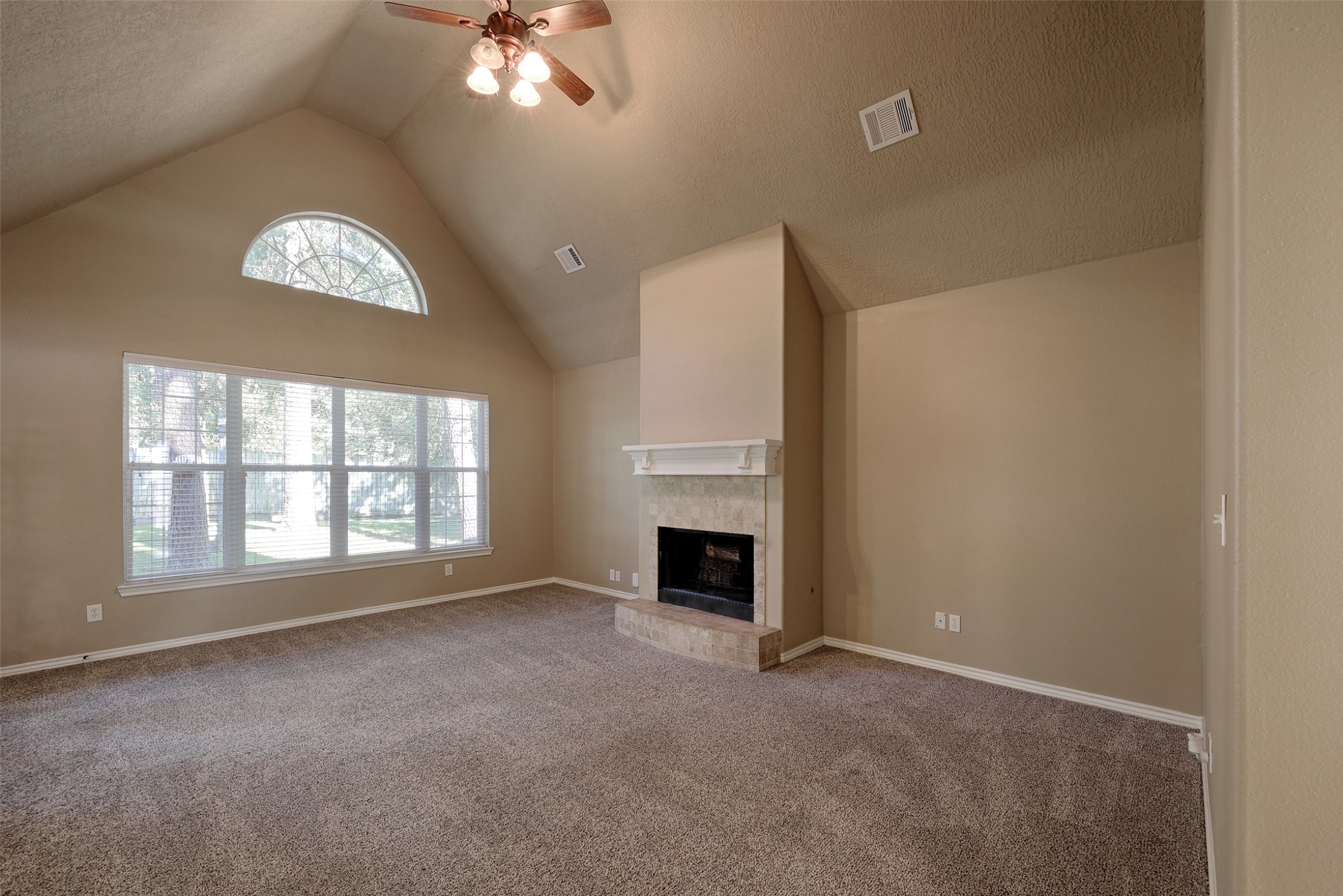14918 Pollux Drive Willis, TX 77318 - Photo 8 of 46 an empty room with windows and fireplace