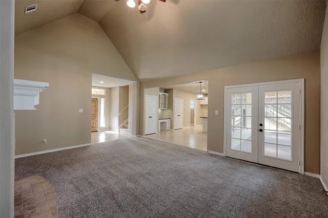 a view of an empty room with a kitchen