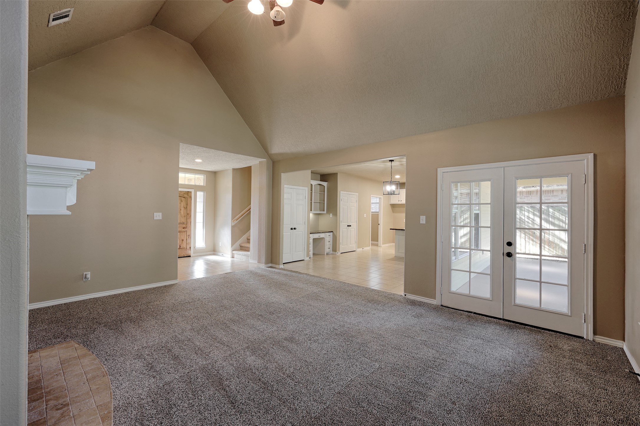 14918 Pollux Drive Willis, TX 77318 - Photo 10 of 46 a view of a big room with windows and chandelier fan