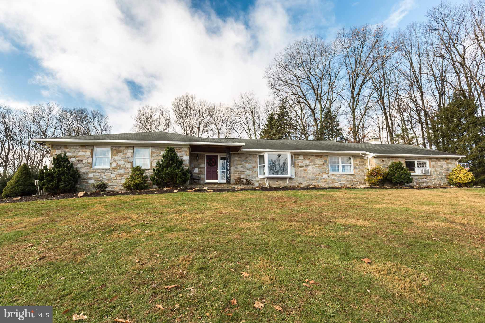 19414 Resh Mill Road Hampstead, MD 21074 - Photo 1 of 25 a front view of a house with a yard and trees