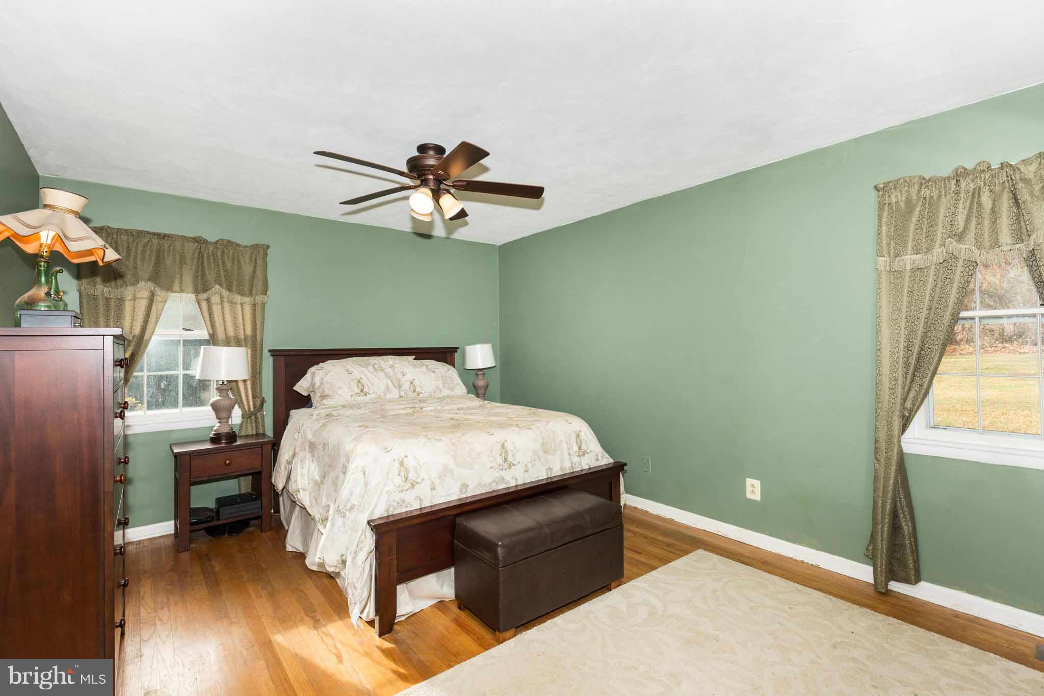 19414 Resh Mill Road Hampstead, MD 21074 - Photo 18 of 25 a bed room with a bed and a chandelier