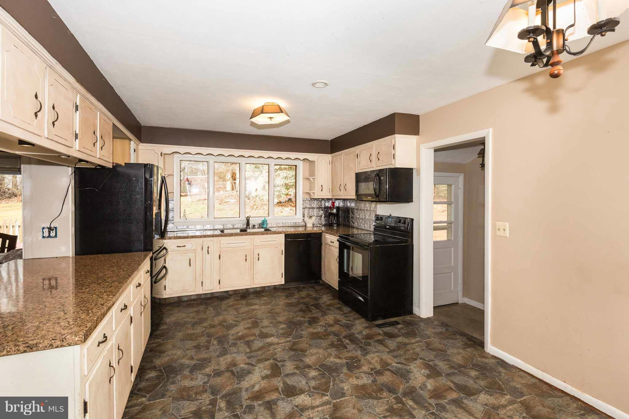 19414 Resh Mill Road Hampstead, MD 21074 - Photo 4 of 25 a large kitchen with stainless steel appliances granite countertop a refrigerator and a stove top oven