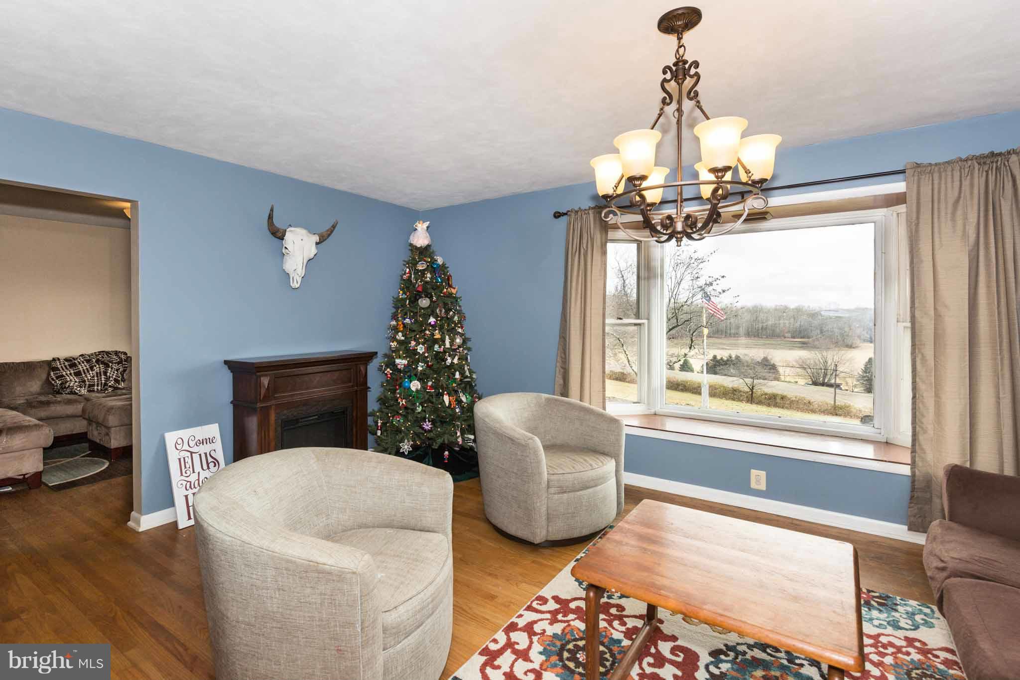 19414 Resh Mill Road Hampstead, MD 21074 - Photo 9 of 25 a living room with furniture and a chandelier