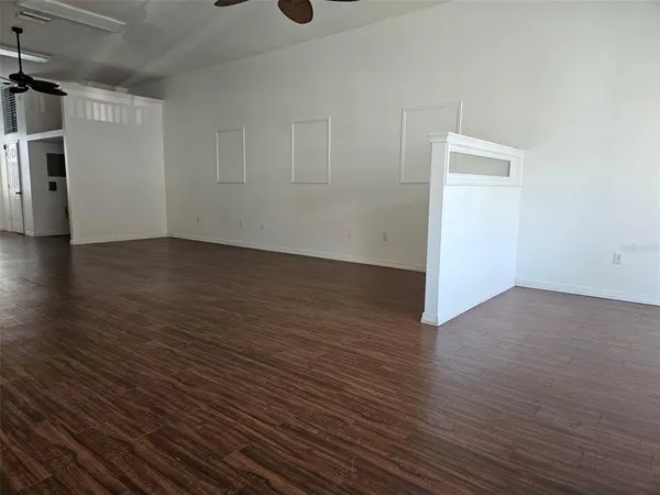 a view of a room with wooden floor