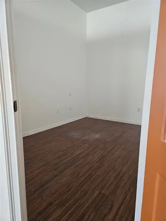 an empty room with wooden floor