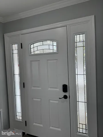 a view of a livingroom with wooden floor and a staircase