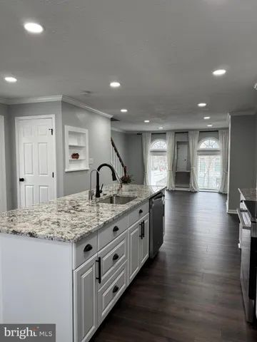 a kitchen with sink cabinets and dining table