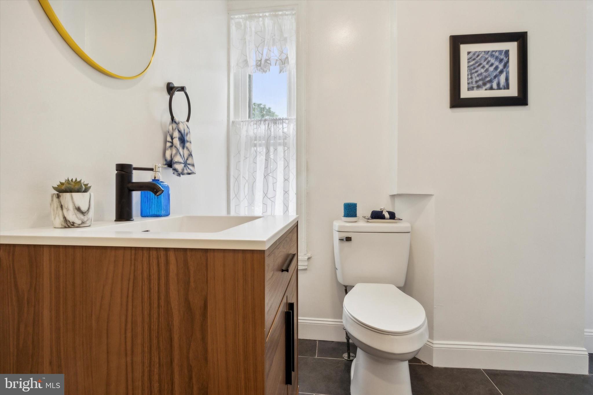 42 East Haines Street, Unit 2 Philadelphia, PA 19144 - Photo 9 of 11 a bathroom with a sink a toilet and a mirror