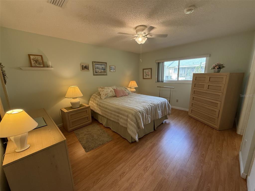 9290 Southwest 89th Terrace, Unit B Ocala, FL 34481 - Photo 11 of 20 a bedroom with a bed and ceiling fan