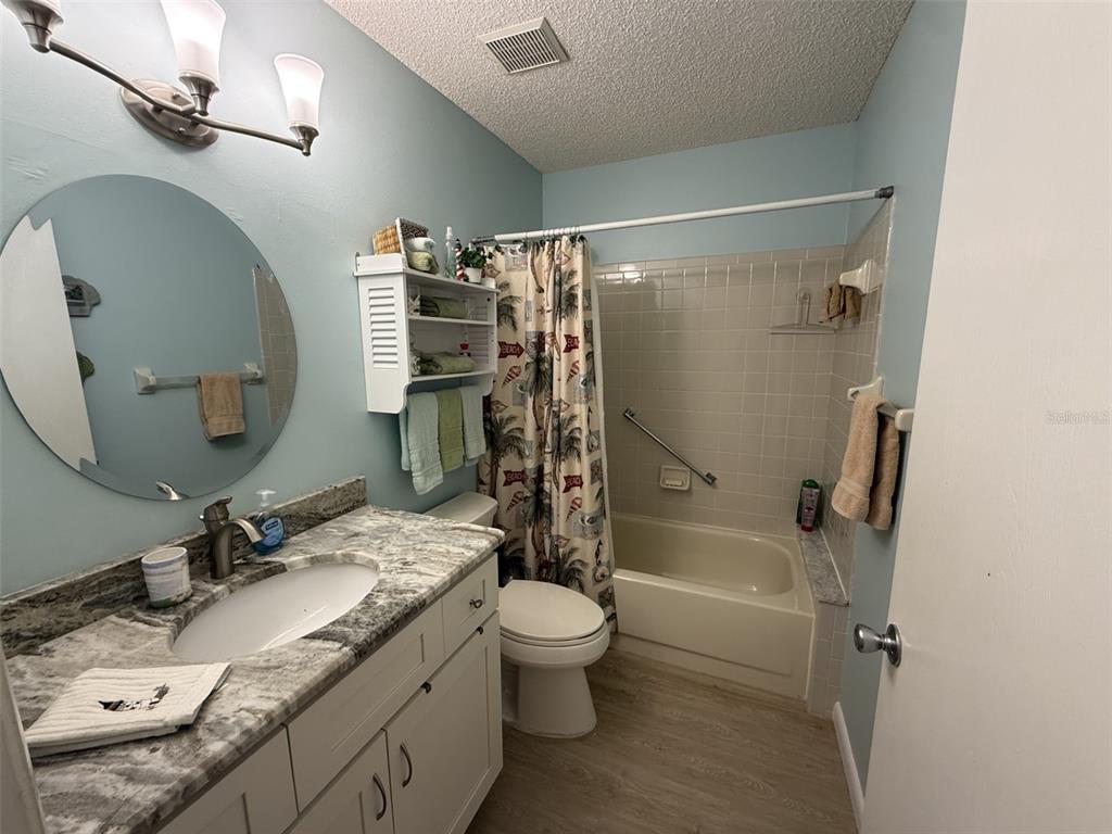 9290 Southwest 89th Terrace, Unit B Ocala, FL 34481 - Photo 18 of 20 a bathroom with a granite countertop sink toilet and shower