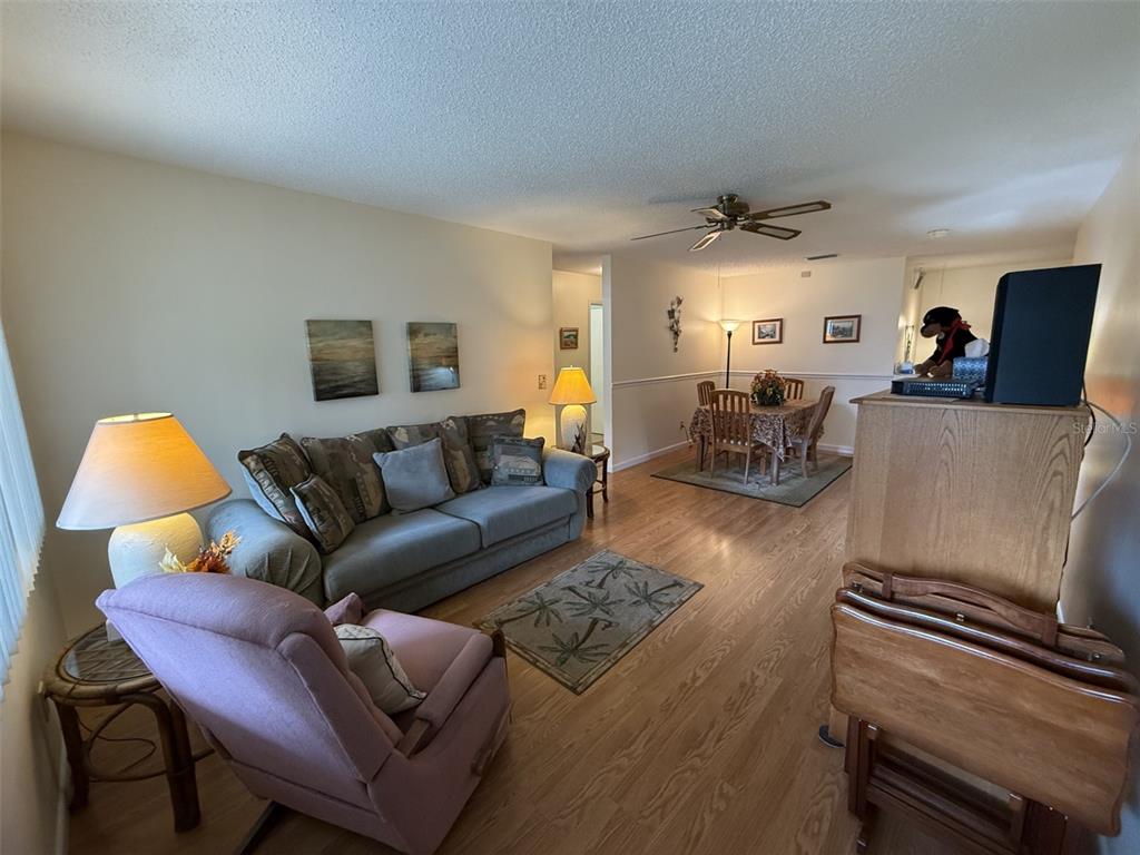 9290 Southwest 89th Terrace, Unit B Ocala, FL 34481 - Photo 2 of 20 a living room with furniture and a lamp