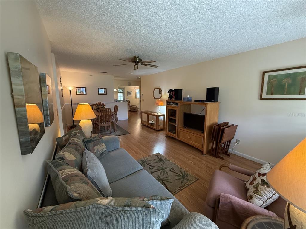 9290 Southwest 89th Terrace, Unit B Ocala, FL 34481 - Photo 3 of 20 a living room with furniture and a lamp