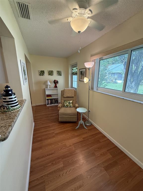 9290 Southwest 89th Terrace, Unit B Ocala, FL 34481 - Photo 8 of 20 a living room with furniture and a chandelier
