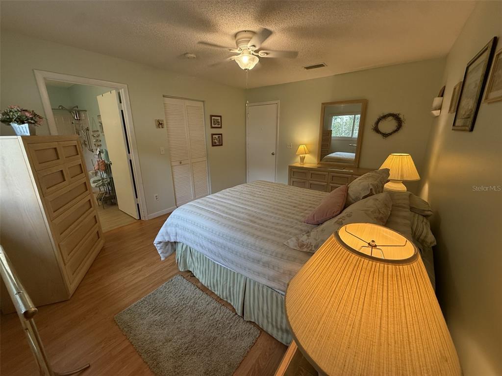 9290 Southwest 89th Terrace, Unit B Ocala, FL 34481 - Photo 10 of 20 a bedroom with a bed and wooden floor