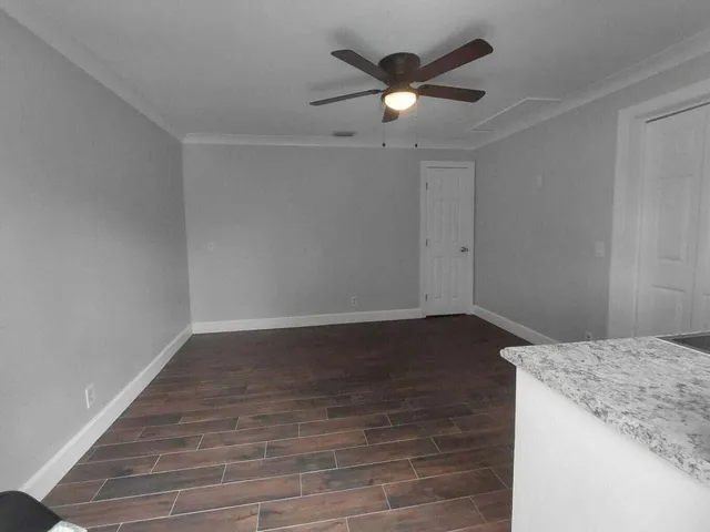 an empty room with wooden floor