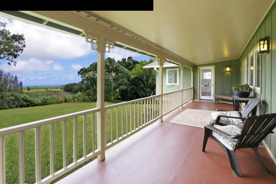a view of a porch with furniture and wooden floor