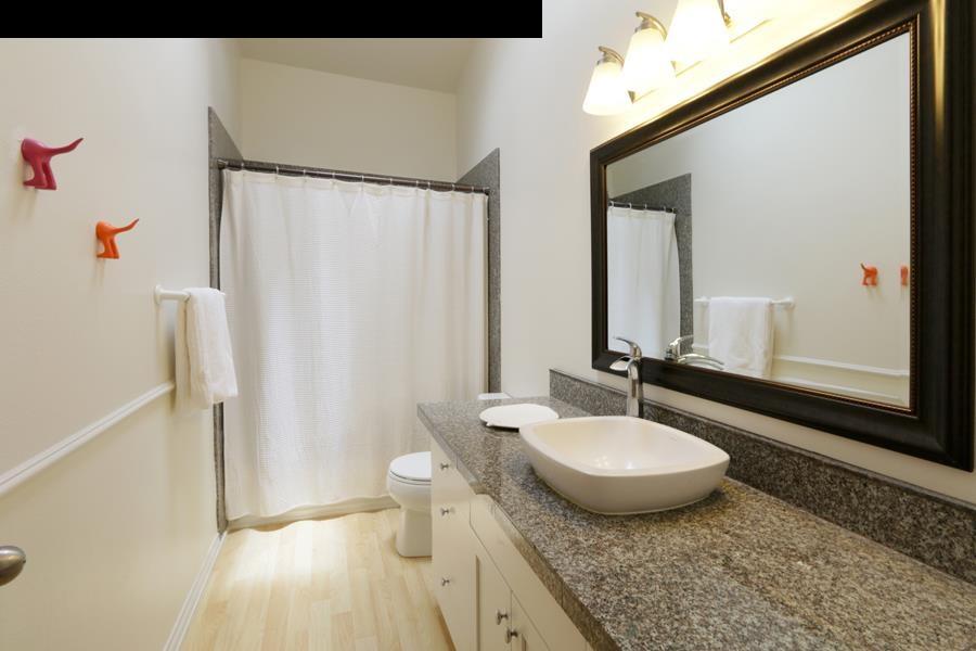 700 Pakanu Street Haiku, HI 96708 - Photo 14 of 28 a bathroom with a granite countertop sink and a mirror