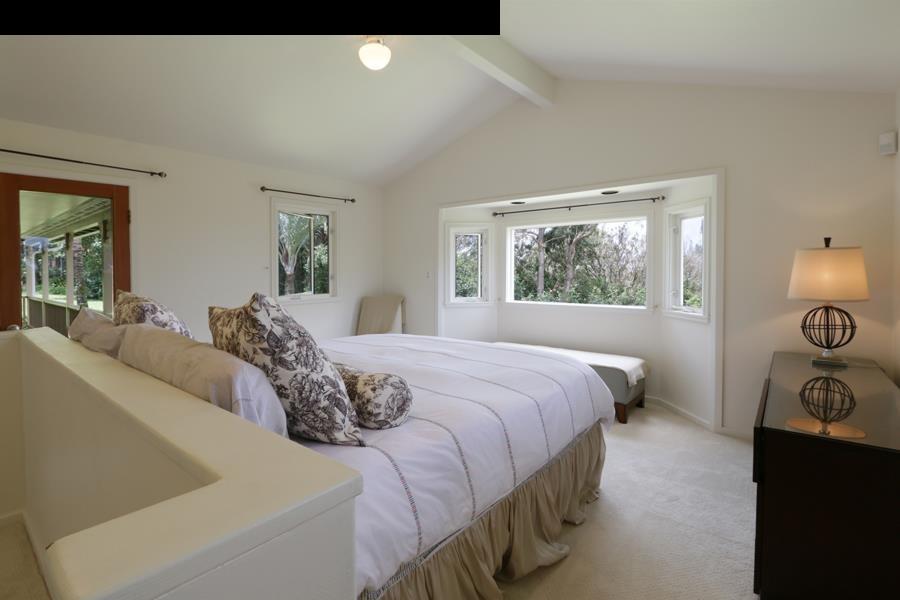 700 Pakanu Street Haiku, HI 96708 - Photo 10 of 28 a bedroom with a bed and window with chair