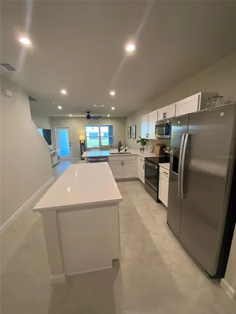 a kitchen with refrigerator and microwave