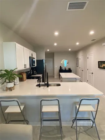 a kitchen with a table chairs sink and stove