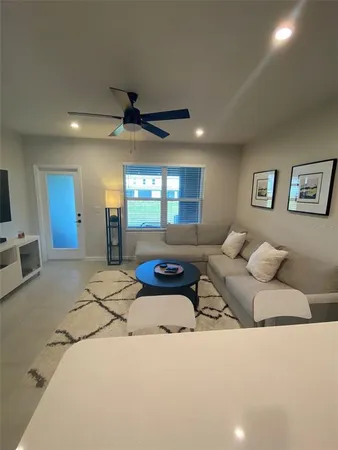 a living room with furniture and a chandelier