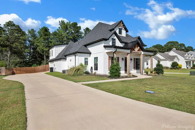 a front view of a house with swimming pool and glass windows