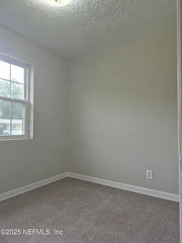 a view of an empty room and closet