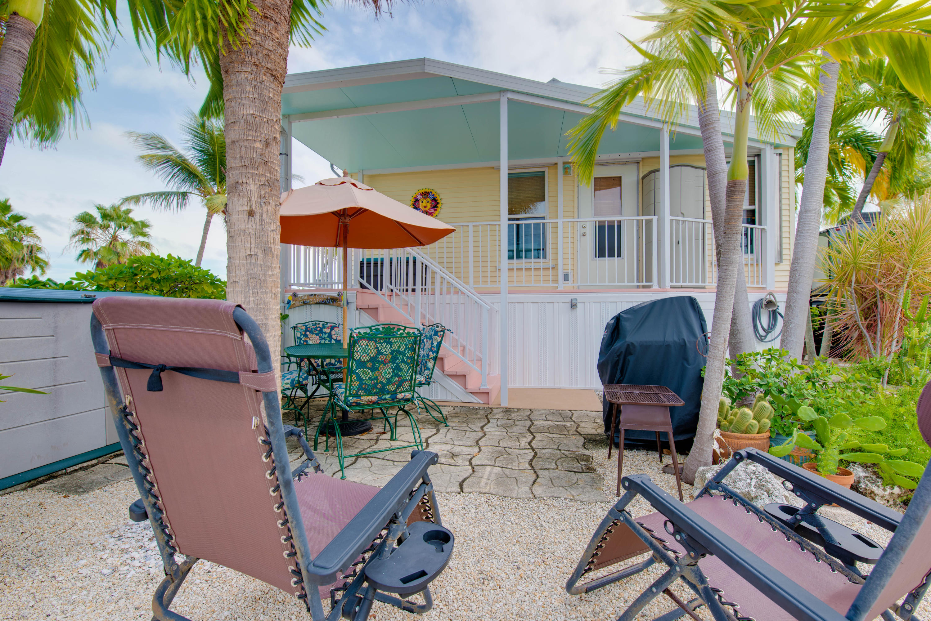 a view of a backyard with furniture and a garden