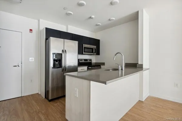 a kitchen with stainless steel appliances a sink stove and refrigerator