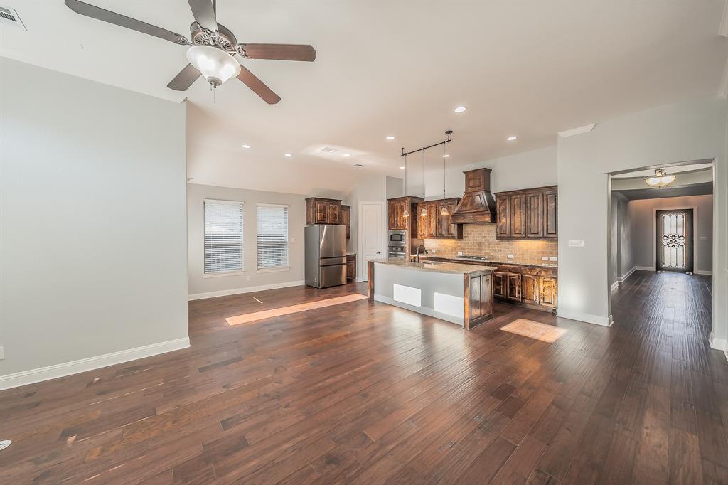 2823 Exeter Drive Trophy Club, TX 76262 - Photo 14 of 40 a living room with stainless steel appliances kitchen island granite countertop furniture wooden floor and a view of kitchen