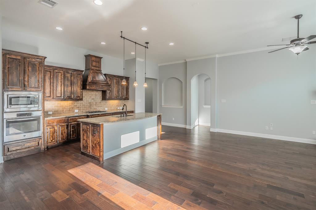 2823 Exeter Drive Trophy Club, TX 76262 - Photo 17 of 40 a large kitchen with kitchen island a sink stainless steel appliances and cabinets
