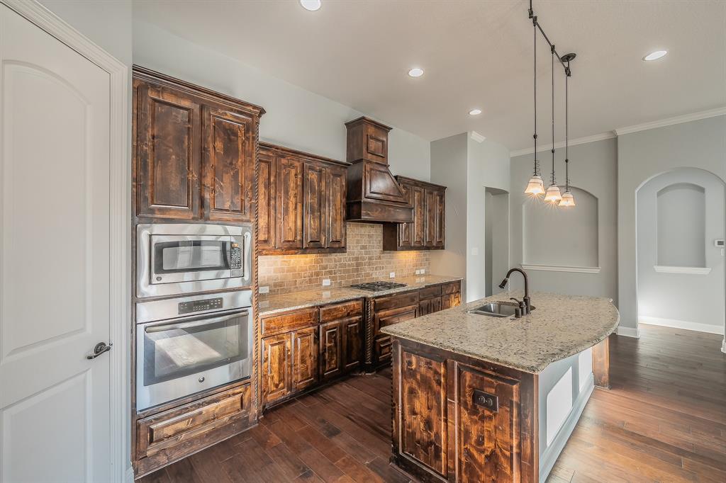 2823 Exeter Drive Trophy Club, TX 76262 - Photo 18 of 40 a kitchen with stainless steel appliances granite countertop a sink and a refrigerator