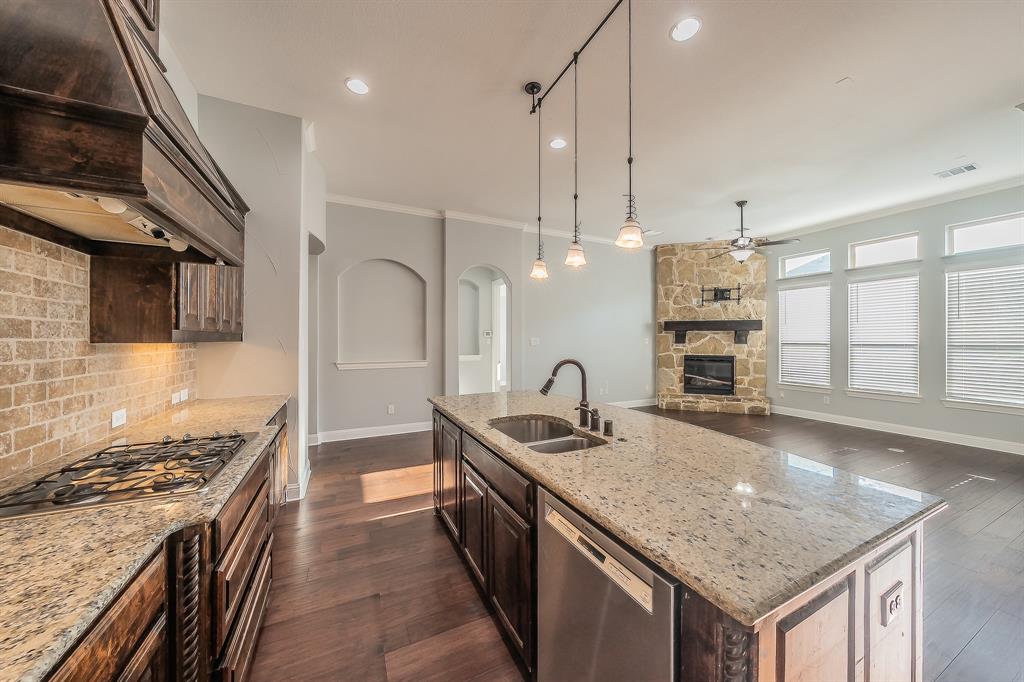 2823 Exeter Drive Trophy Club, TX 76262 - Photo 21 of 40 a kitchen with stainless steel appliances granite countertop a sink a stove and a refrigerator