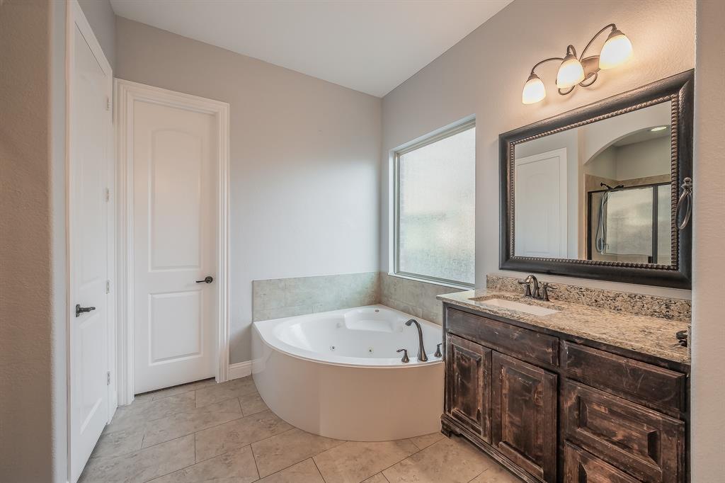 2823 Exeter Drive Trophy Club, TX 76262 - Photo 25 of 40 a bathroom with a tub sink and mirror