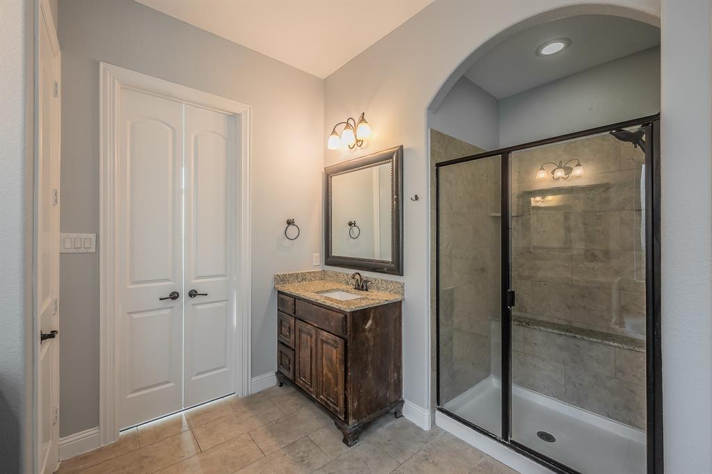 2823 Exeter Drive Trophy Club, TX 76262 - Photo 26 of 40 a bathroom with a granite countertop sink mirror and shower