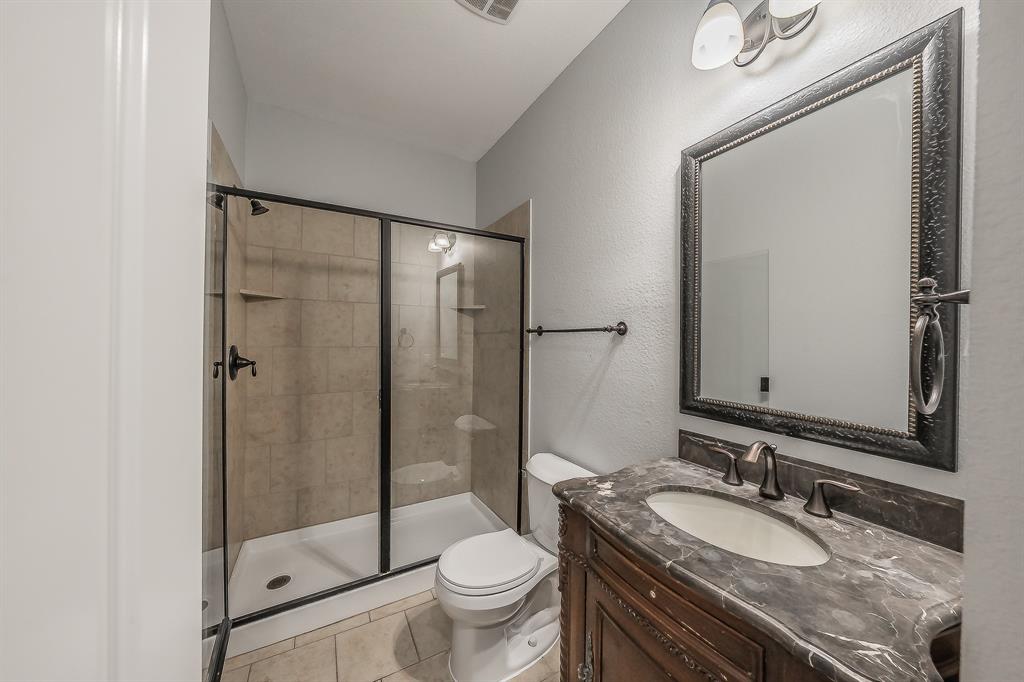 2823 Exeter Drive Trophy Club, TX 76262 - Photo 33 of 40 a bathroom with a granite countertop sink toilet mirror and shower