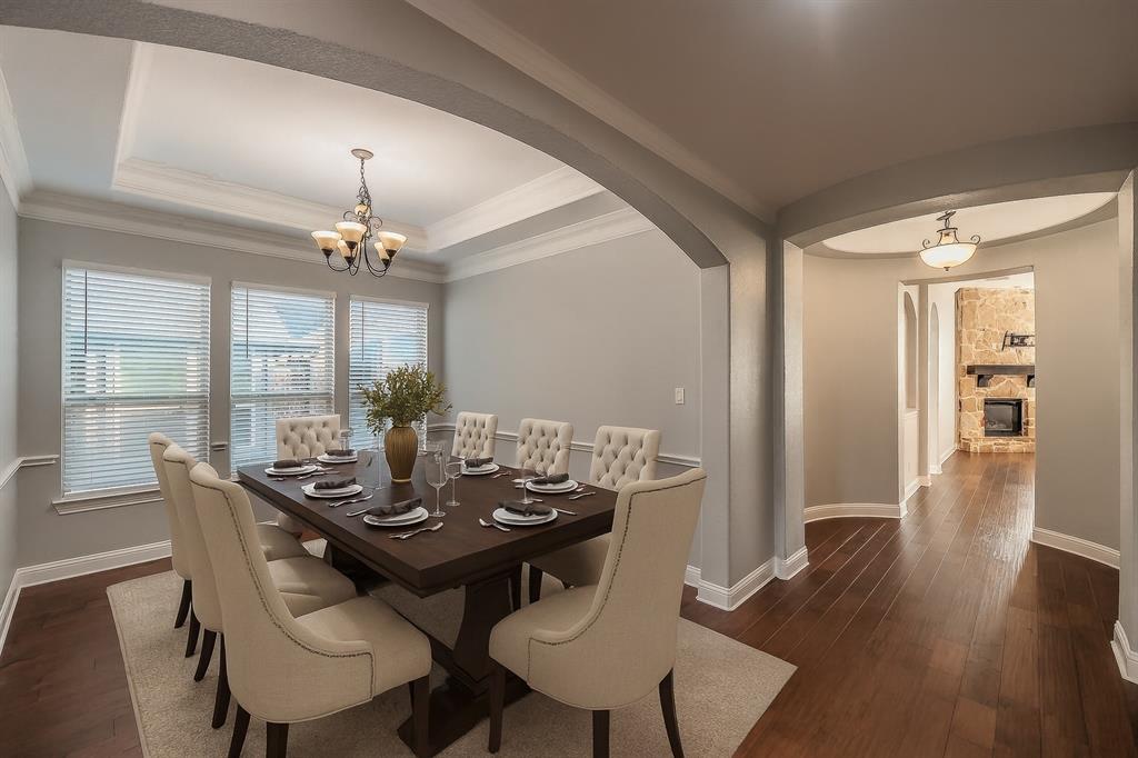 2823 Exeter Drive Trophy Club, TX 76262 - Photo 5 of 40 a view of a dining room with furniture wooden floor and chandelier