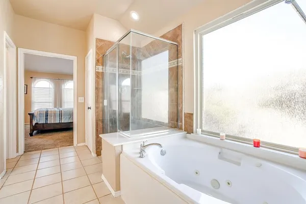 a spacious bathroom with a granite countertop sink a mirror and a shower