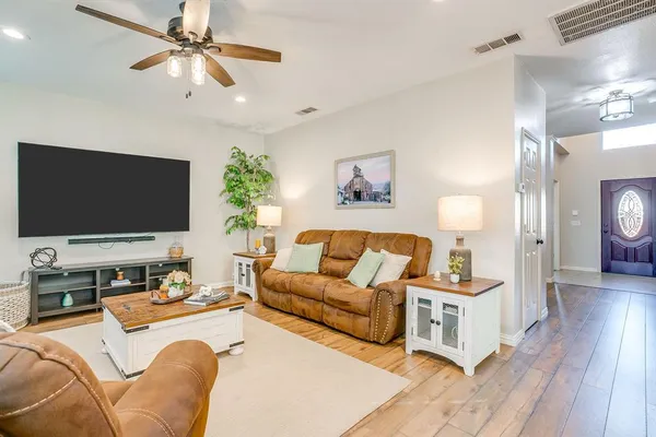 a living room with furniture and a flat screen tv
