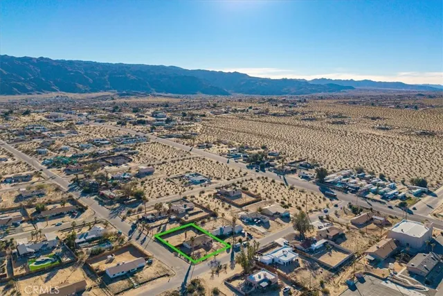 an aerial view of residential house and sandy dunes