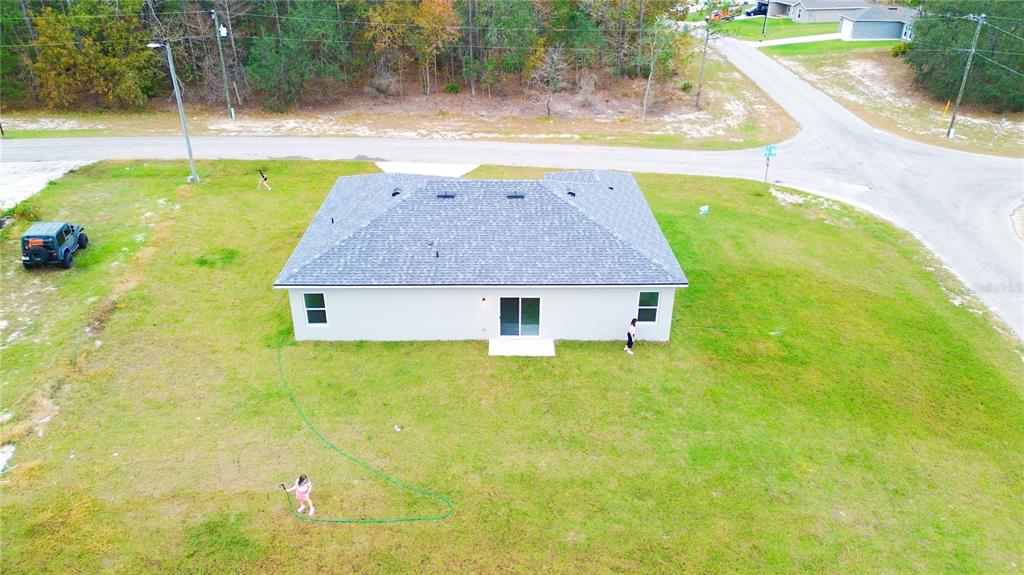 6325 Southwest 144th Lane Road Ocala, FL 34473 - Photo 30 of 31 a backyard of a house with swimming pool
